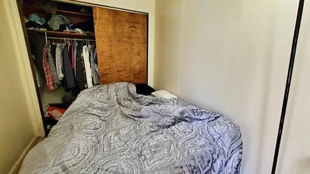 a bedroom with a bed and a mirror