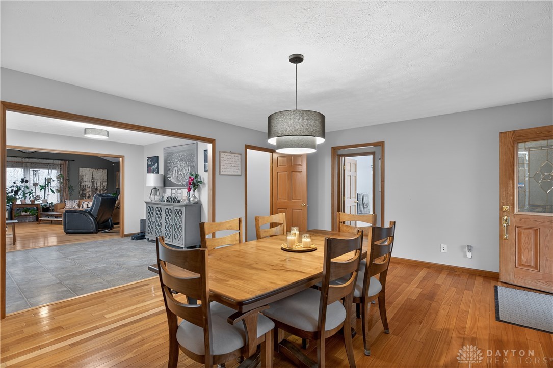5264 Frazier-Guy Road Sidney, OH 45365 - Photo 10 of 51 This inviting dining room features warm hardwood floors and an open entryway to the living area.