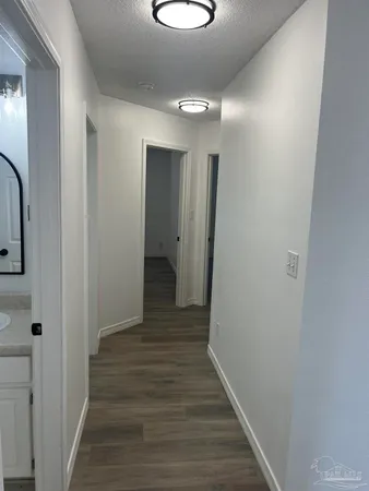 a view of a hallway with wooden floor