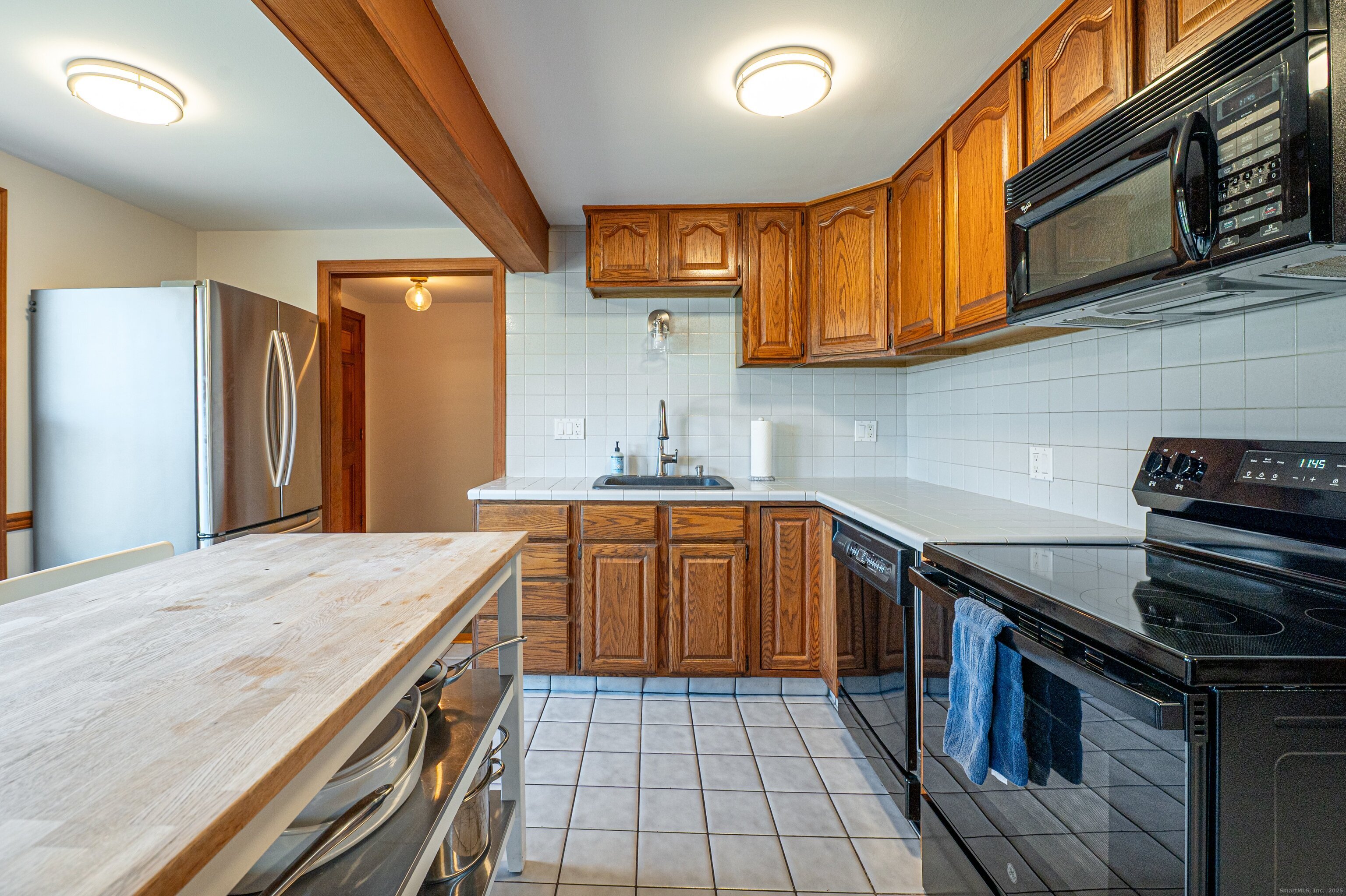 975 Wolf Hill Road Cheshire, CT 06410 - Photo 11 of 40 a kitchen with stainless steel appliances granite countertop a stove sink and cabinets