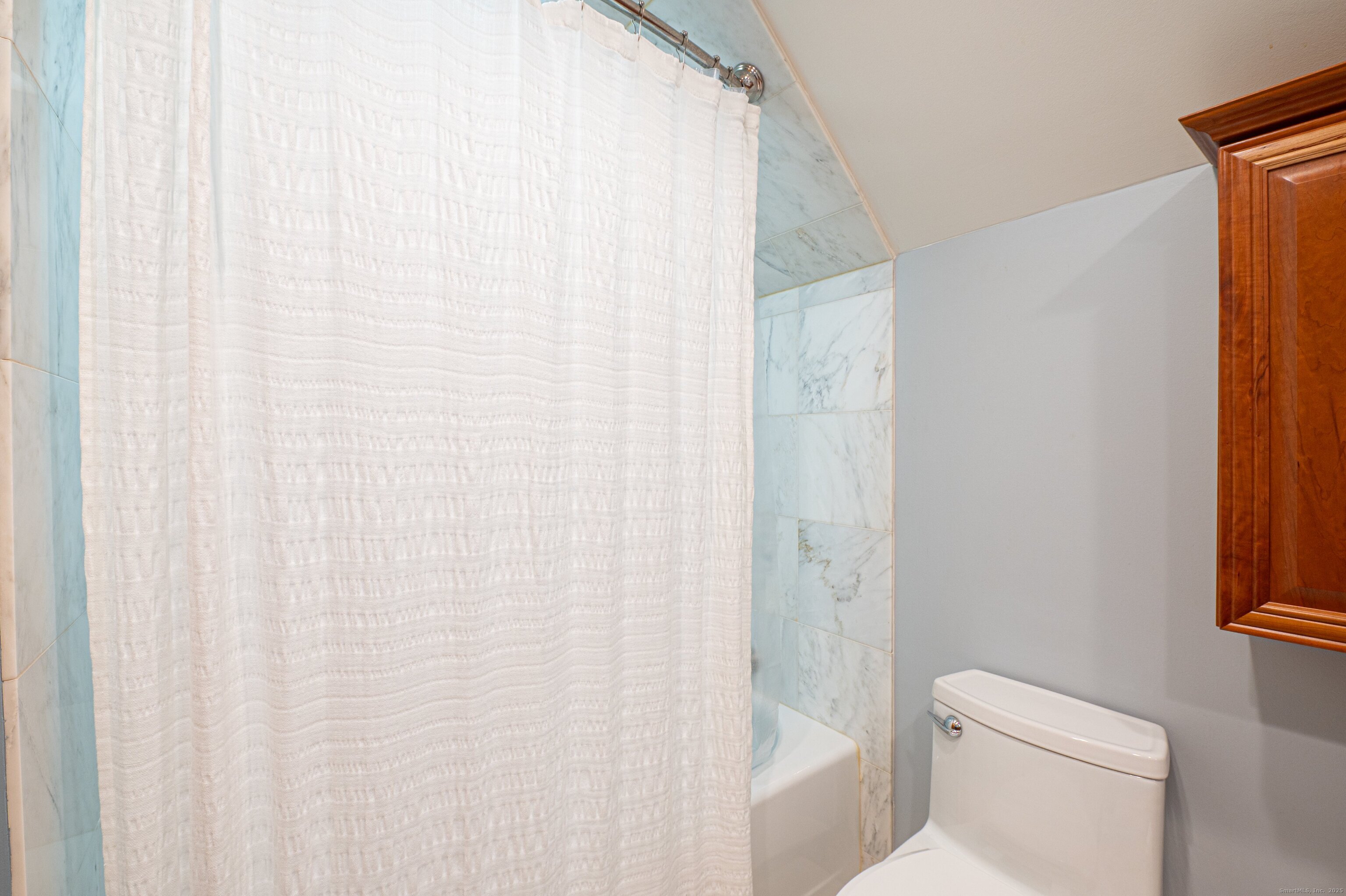 975 Wolf Hill Road Cheshire, CT 06410 - Photo 23 of 40 a white toilet sitting next to a shower curtain