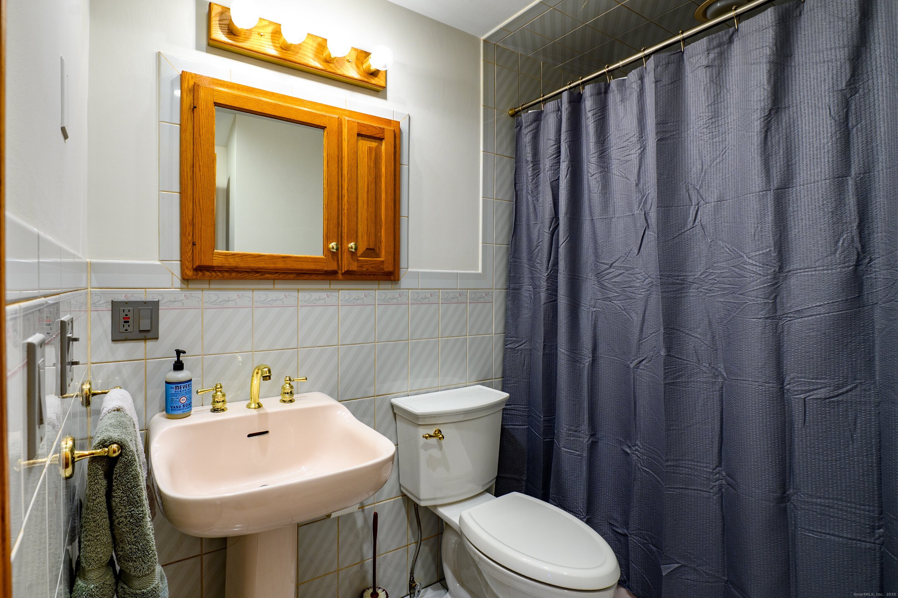 975 Wolf Hill Road Cheshire, CT 06410 - Photo 24 of 40 a bathroom with a sink a toilet and mirror