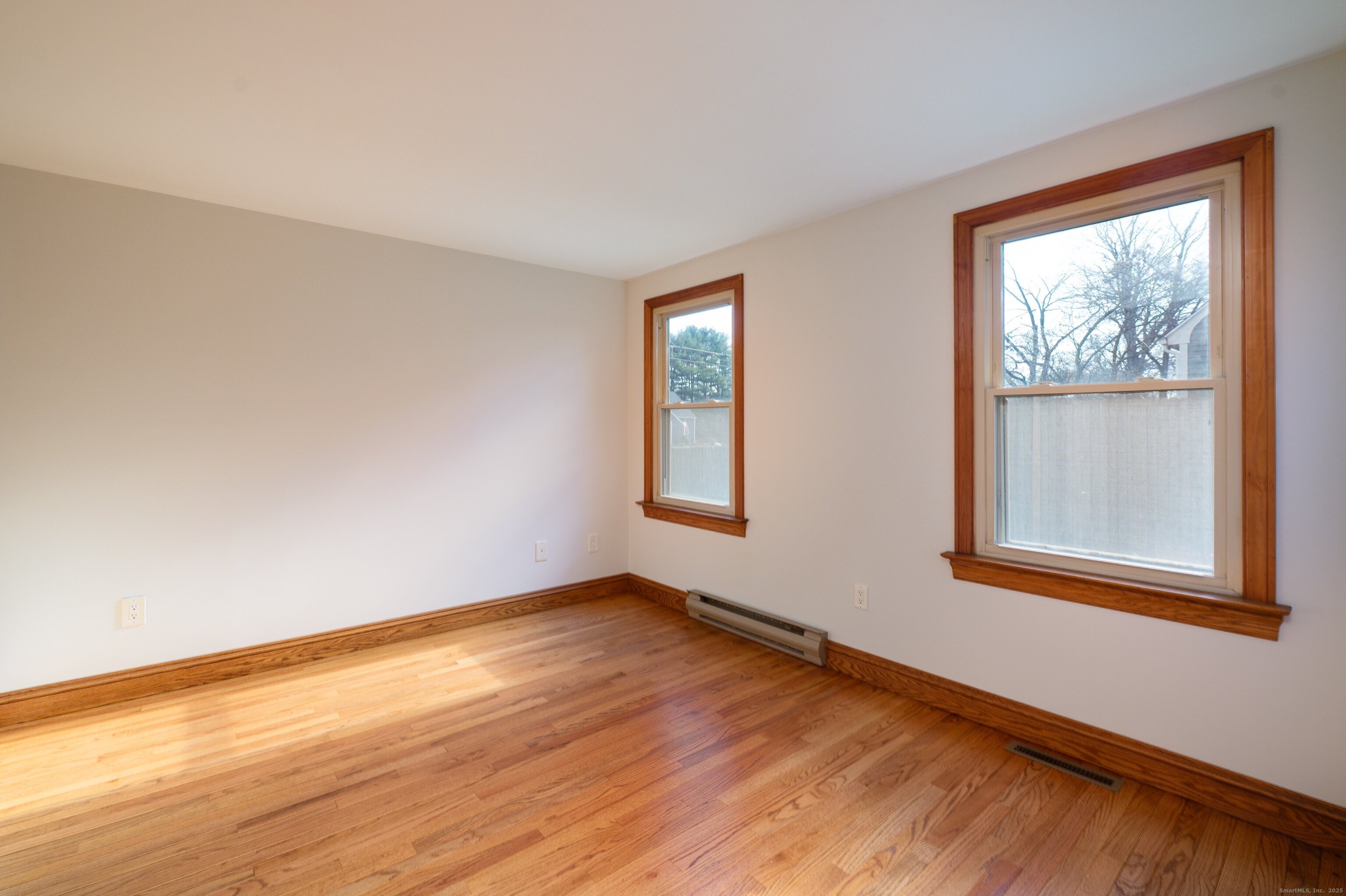 975 Wolf Hill Road Cheshire, CT 06410 - Photo 26 of 40 a view of an empty room with wooden floor and a window