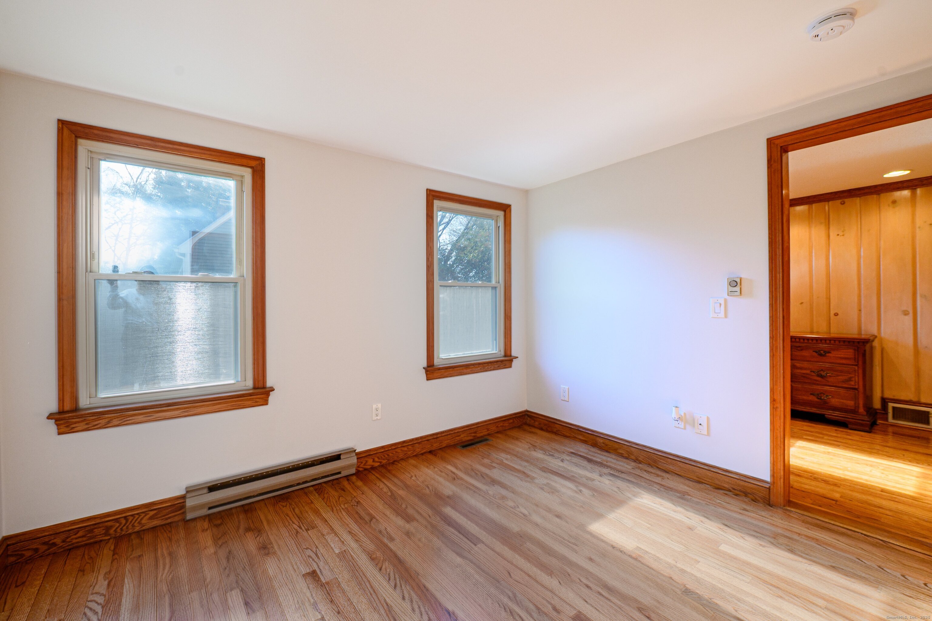 975 Wolf Hill Road Cheshire, CT 06410 - Photo 27 of 40 an empty room with wooden floor and windows