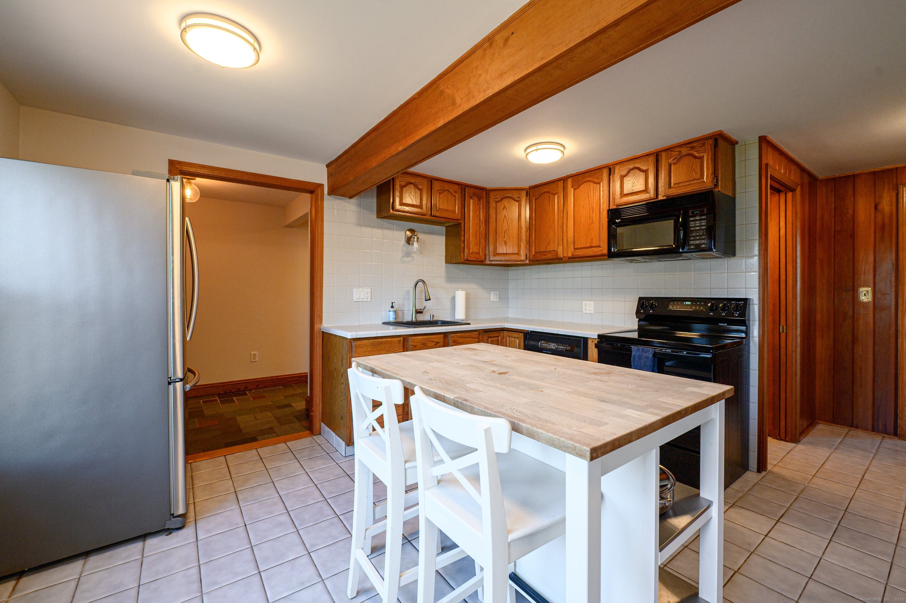 975 Wolf Hill Road Cheshire, CT 06410 - Photo 10 of 40 a kitchen with a sink a microwave and cabinets