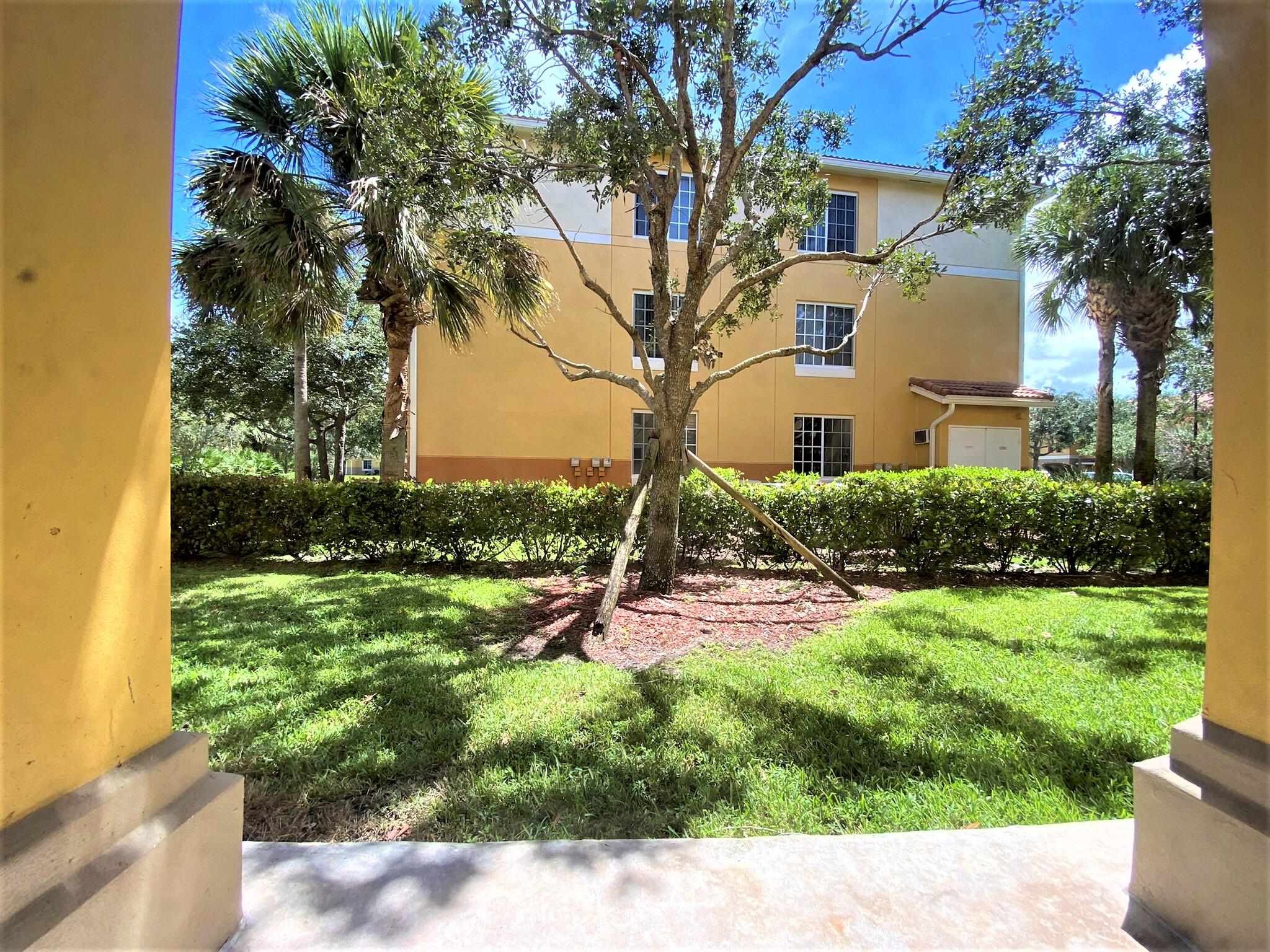6768 Heritage Grande, Unit 106 Boynton Beach, FL 33437 - Photo 11 of 56 a backyard of a house with a garden and outdoor seating