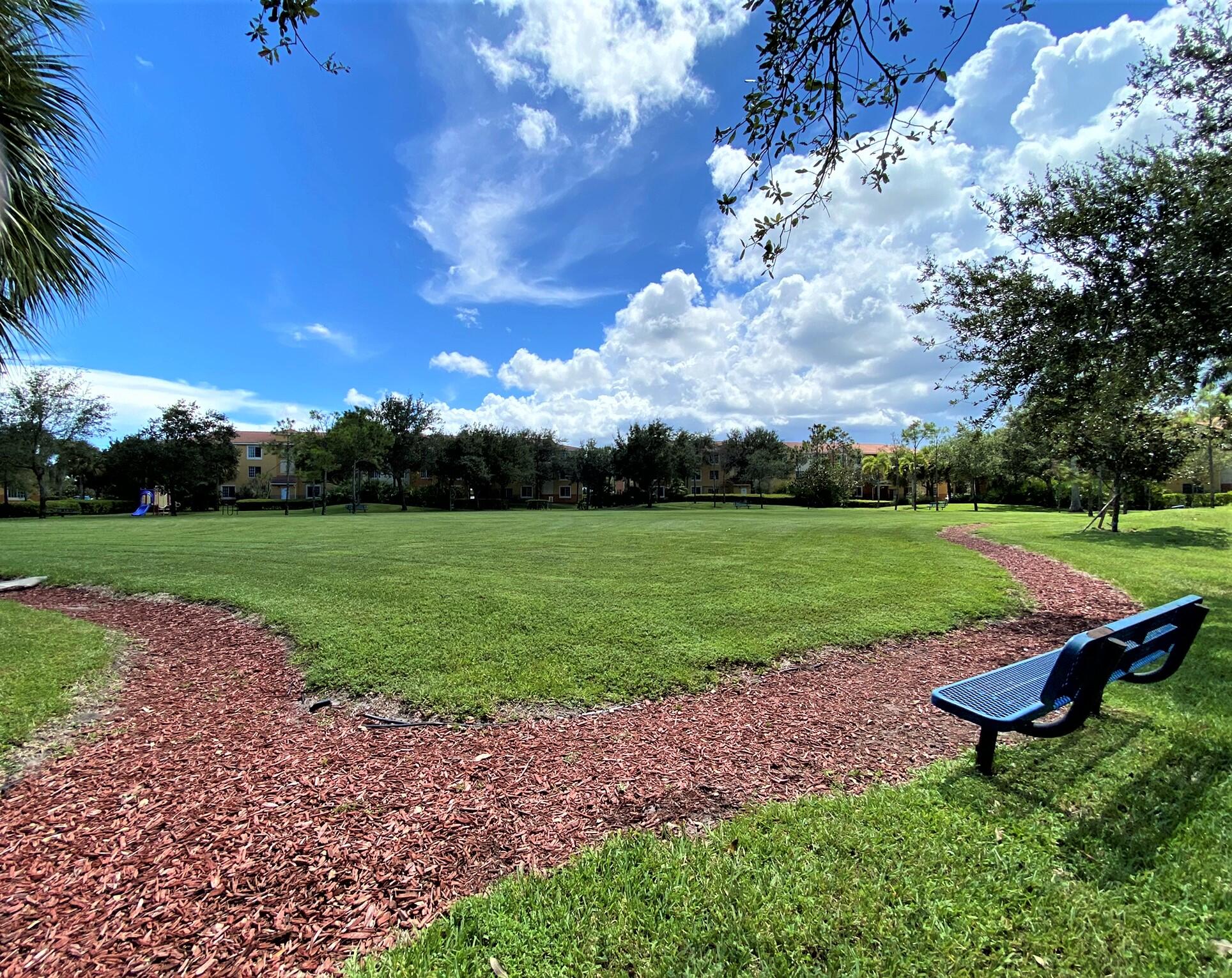 6768 Heritage Grande, Unit 106 Boynton Beach, FL 33437 - Photo 31 of 56 a view of a park with large trees