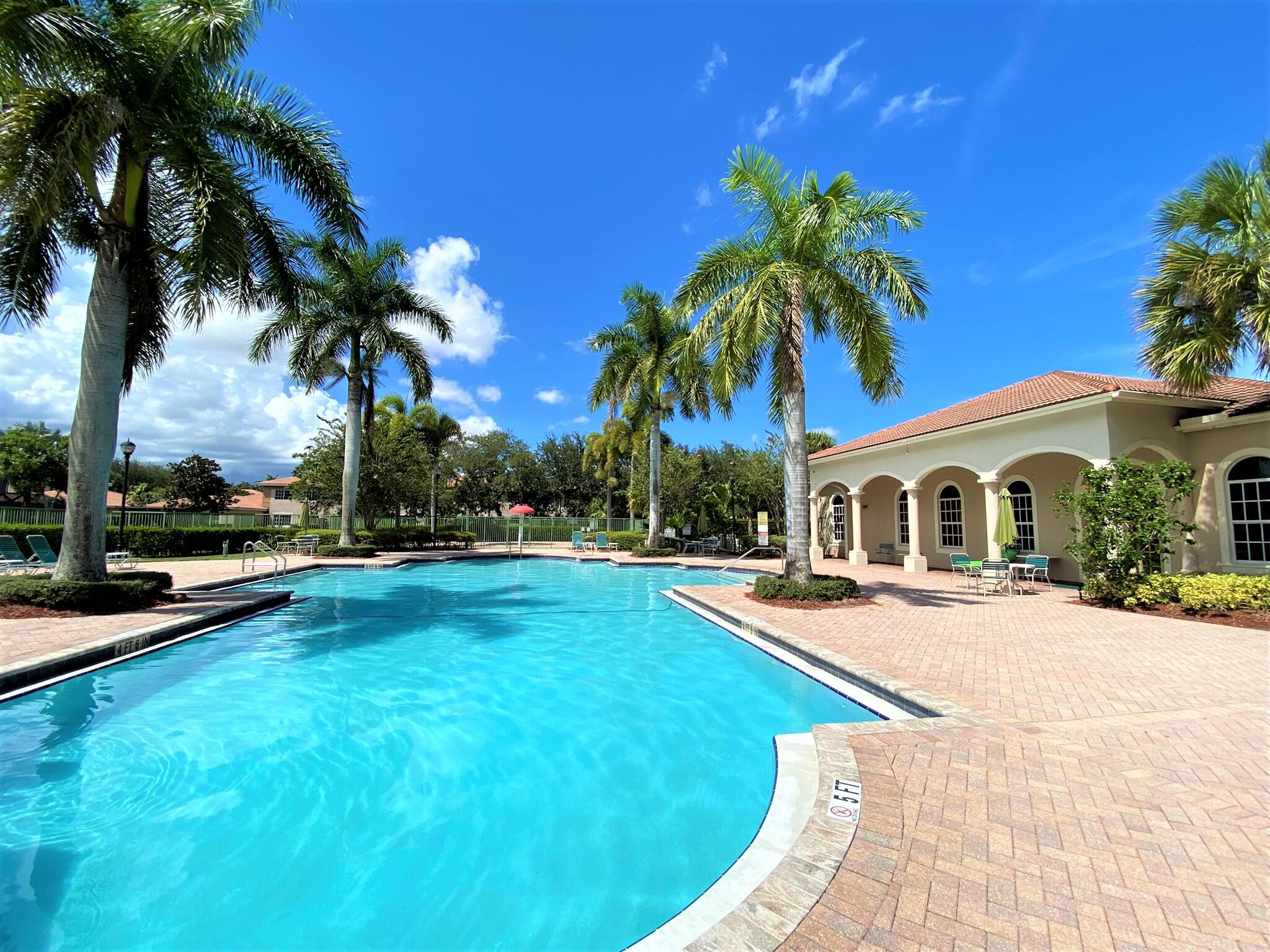 6768 Heritage Grande, Unit 106 Boynton Beach, FL 33437 - Photo 34 of 56 a view of a house with swimming pool and sitting area
