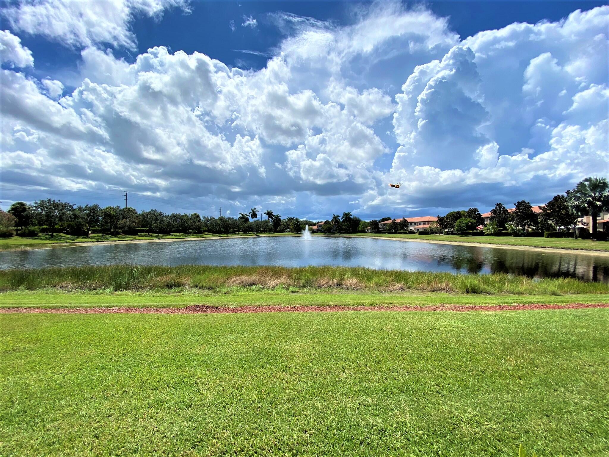 6768 Heritage Grande, Unit 106 Boynton Beach, FL 33437 - Photo 36 of 56 a view of a lake with houses in the back