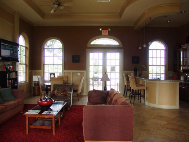 6768 Heritage Grande, Unit 106 Boynton Beach, FL 33437 - Photo 4 of 56 a living room with furniture and a large window