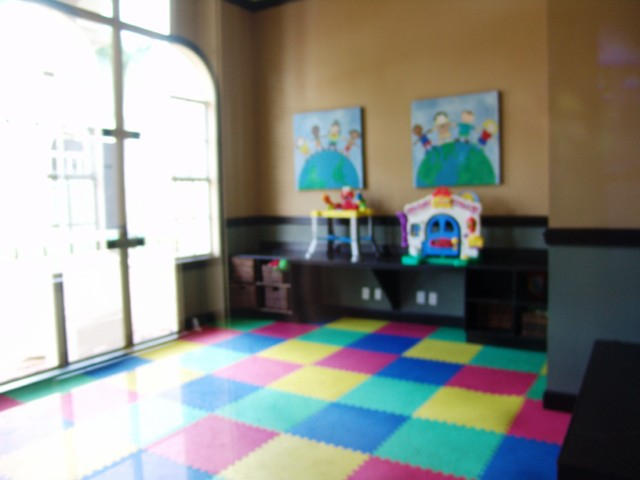 6768 Heritage Grande, Unit 106 Boynton Beach, FL 33437 - Photo 41 of 56 a living room with furniture and a floor to ceiling window
