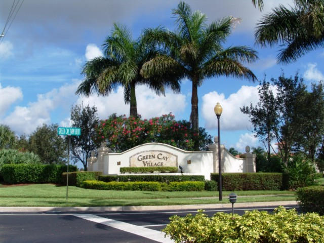 6768 Heritage Grande, Unit 106 Boynton Beach, FL 33437 - Photo 43 of 56 a front view of a house with a yard and palm trees