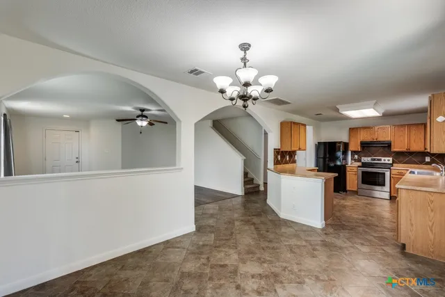 a view of a living room and kitchen with furniture