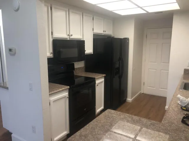 a kitchen with a refrigerator and cabinets