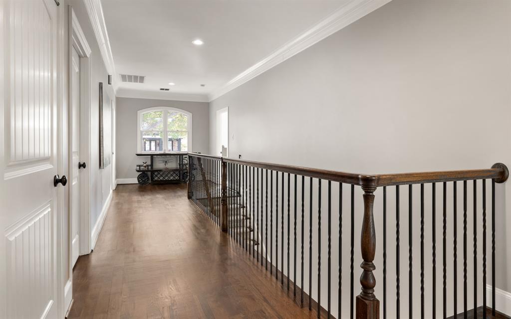 4715 Purdue Avenue Dallas, TX 75209 - Photo 15 of 30 a view of a hallway with wooden floor and windows