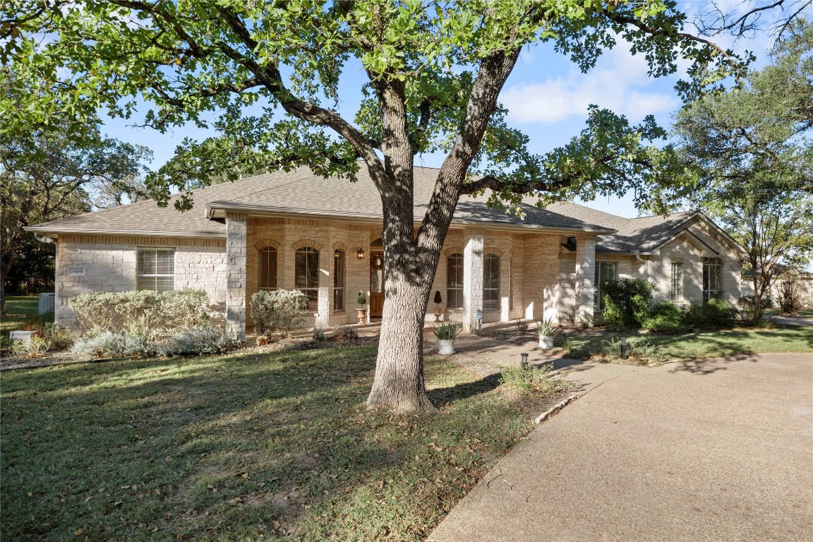 Approaching the home from the circle drive you are greeted under a tree lined canopy by a warm and inviting covered front porch - an entertaining space all on its own, makes for an impressive welcome.