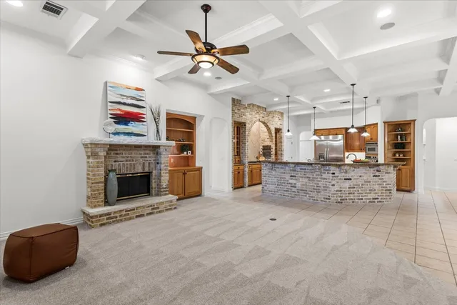 a view of a livingroom with a fireplace and a ceiling fan