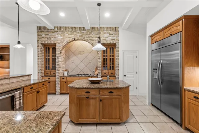 a bathroom with a granite countertop sink a mirror and shower