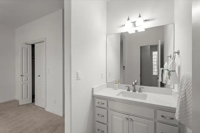 a bathroom with a double vanity sink and a mirror