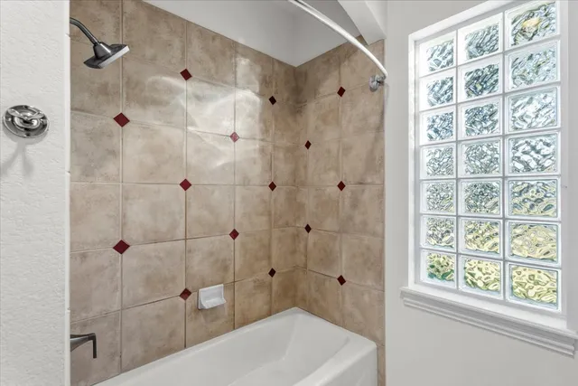 a bathroom with a shower and a bath tub