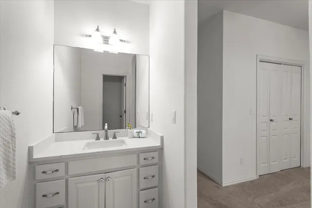 a bathroom with a sink vanity and mirror