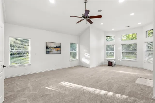 a view of a livingroom with a ceiling fan and window