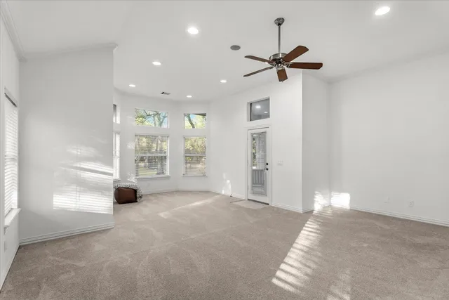 a view of a livingroom with a ceiling fan and window