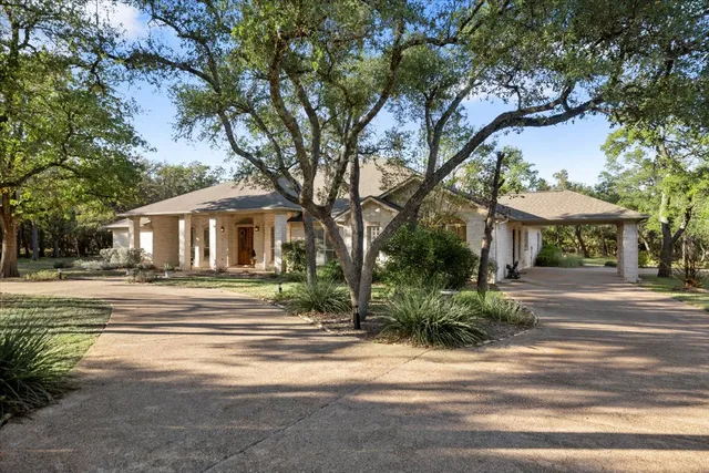 a view of a trees and brick house