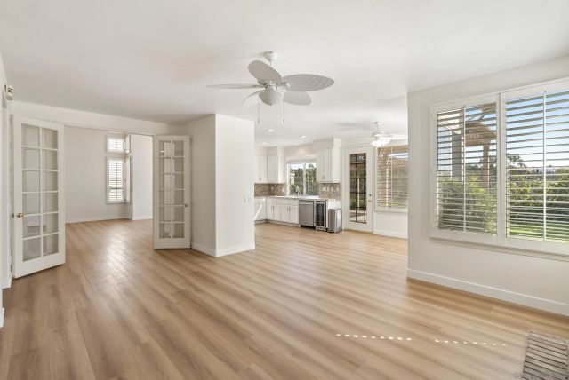a kitchen with a refrigerator a sink and a stove top oven
