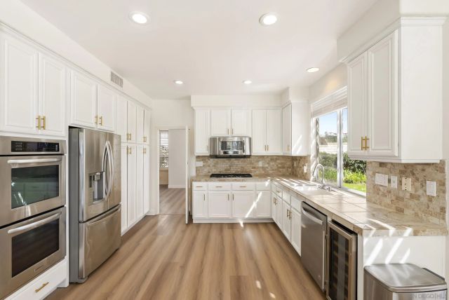 a view of a kitchen with a sink and wooden floor