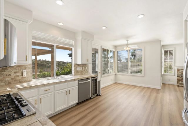 a view of an empty room with a fireplace and a window