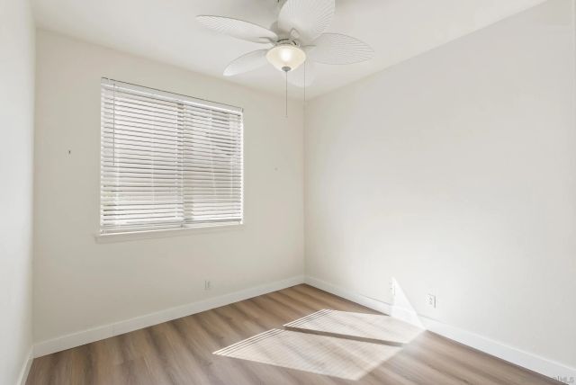 a view of a kitchen with wooden floor and staircase