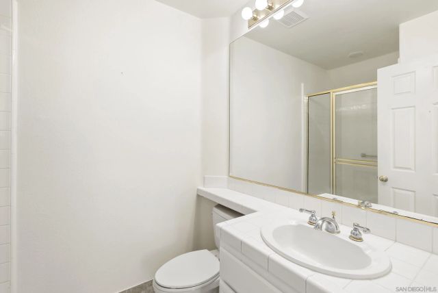 a view of a room with wooden floor and windows