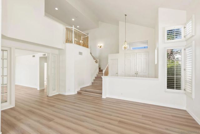 a view of a room with wooden floor and staircase