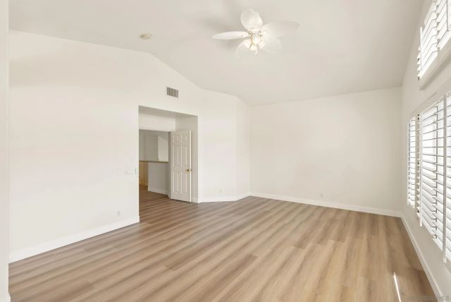 a bathroom with double vanity sinks a large mirror and a bathtub