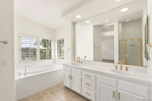 a hallway with wooden floor and staircase