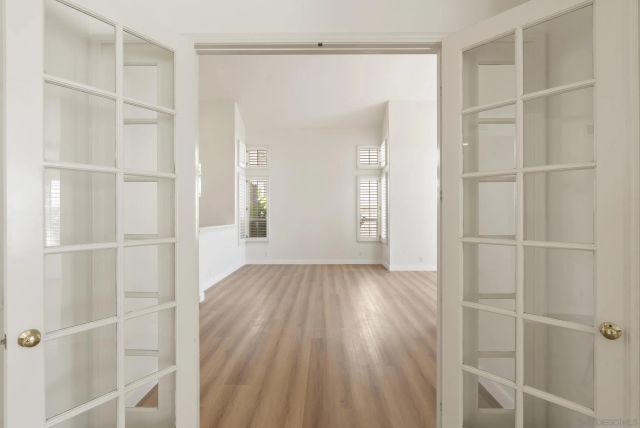 a view of empty room with fireplace and wooden floor