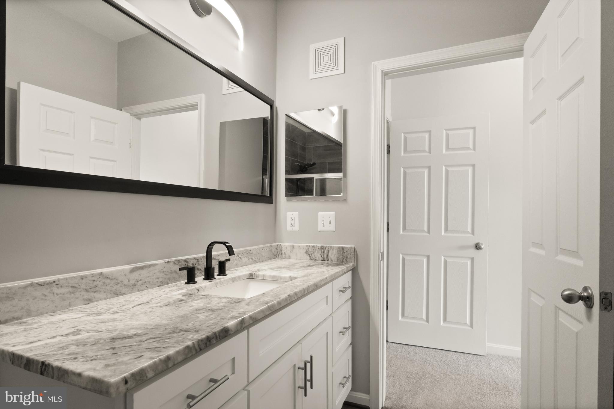 9541 Center Street Manassas, VA 20110 - Photo 23 of 41 a bathroom with a sink and vanity