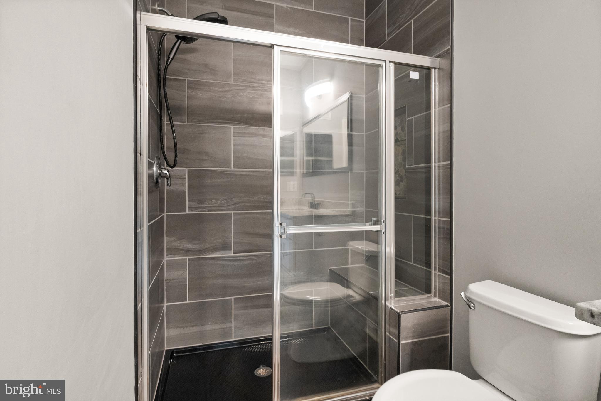 9541 Center Street Manassas, VA 20110 - Photo 24 of 41 a bathroom with a toilet and a glass door