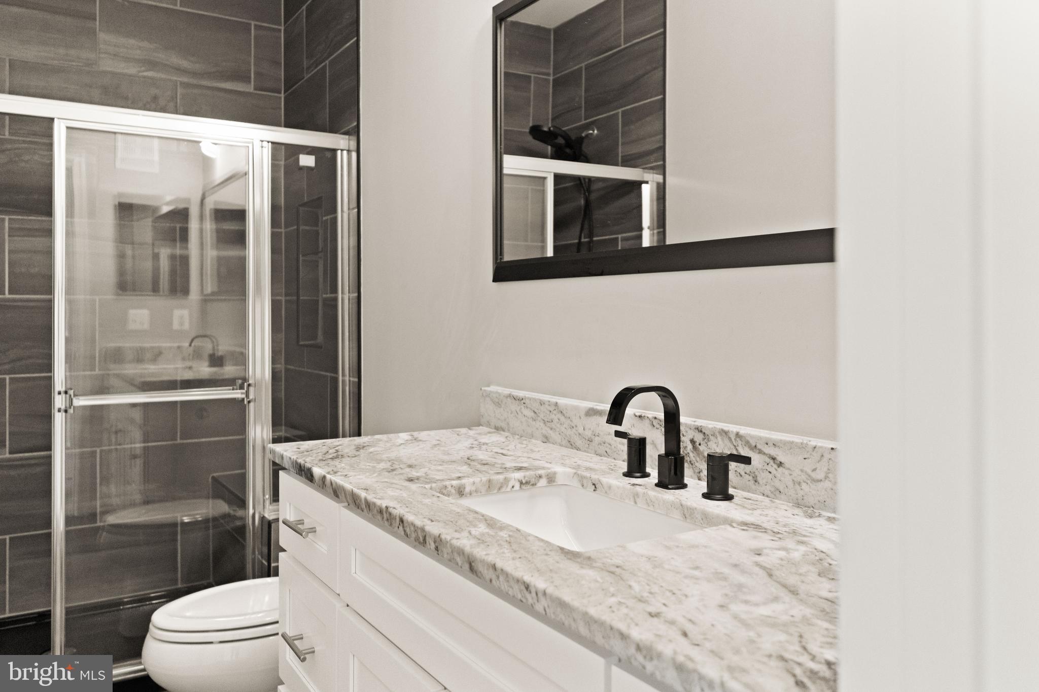 9541 Center Street Manassas, VA 20110 - Photo 30 of 41 a bathroom with a sink and mirror