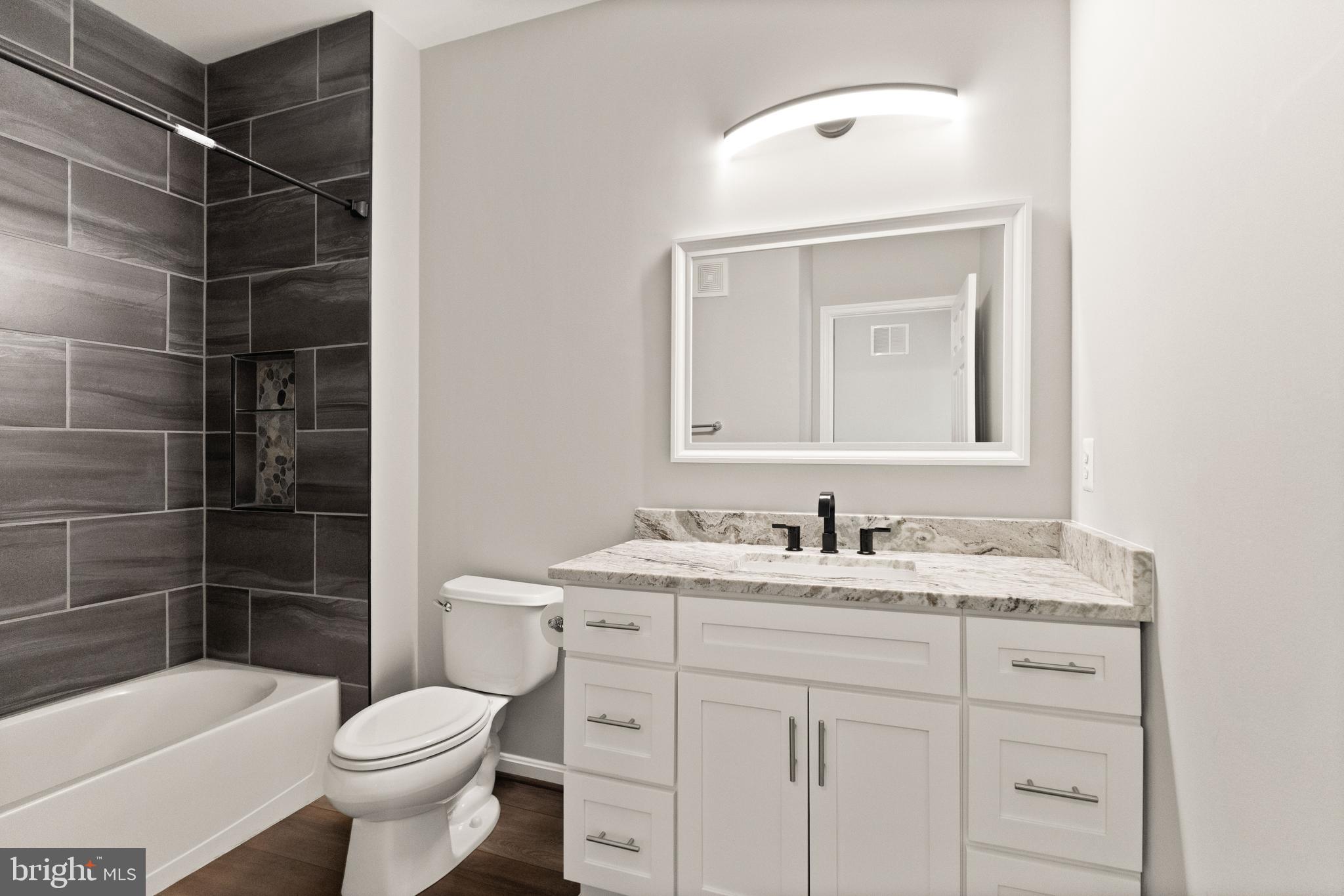 9541 Center Street Manassas, VA 20110 - Photo 34 of 41 a bathroom with a sink a toilet and shower