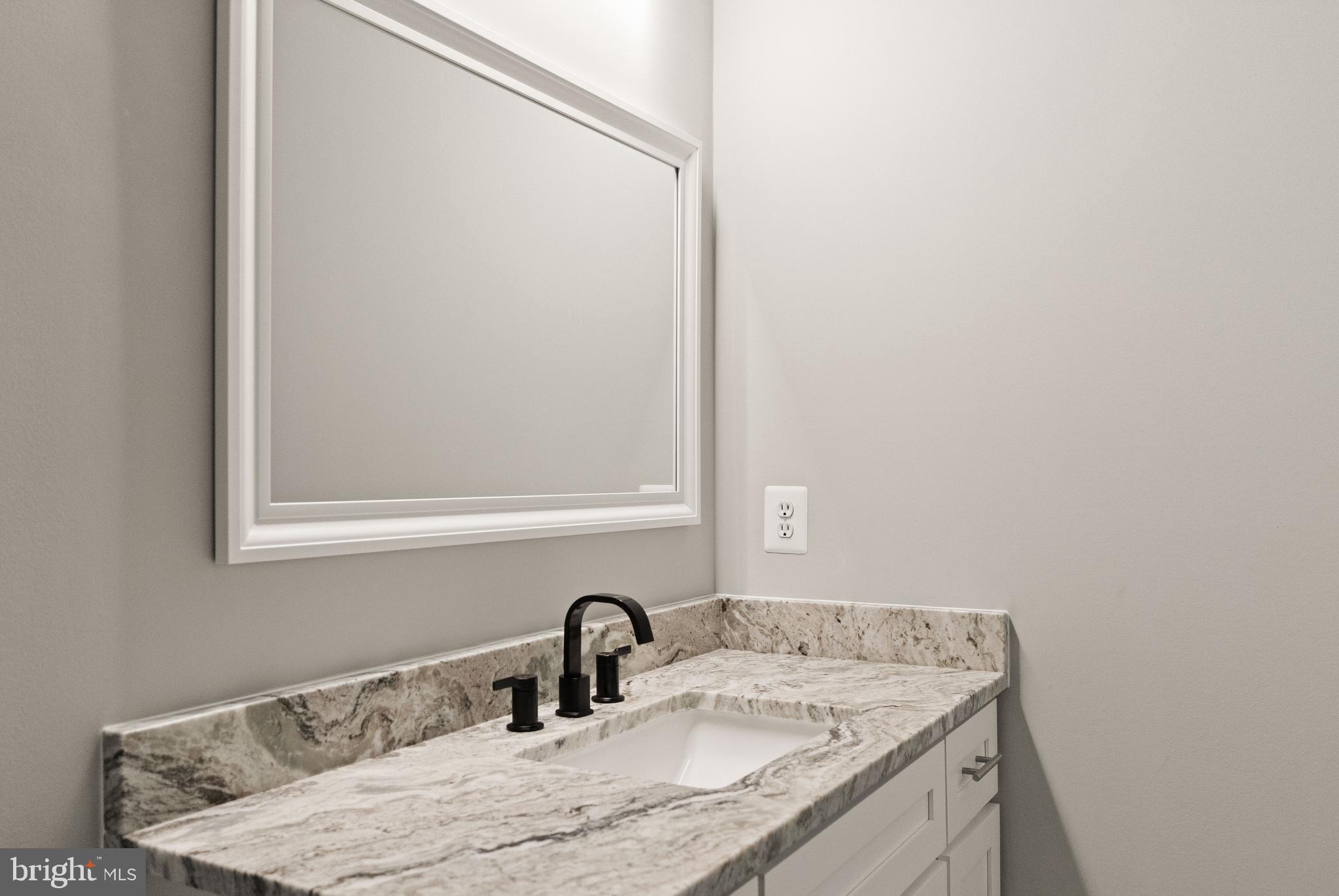 9541 Center Street Manassas, VA 20110 - Photo 38 of 41 a bathroom with a granite countertop sink and a mirror