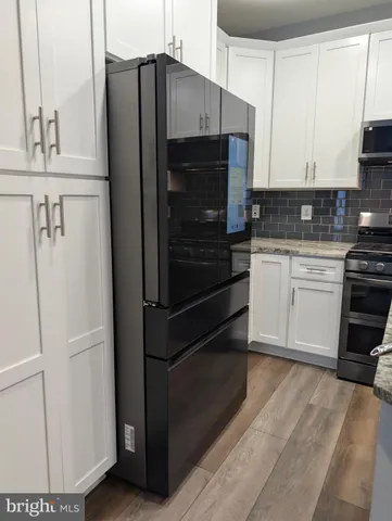 a kitchen with stainless steel appliances a refrigerator sink and cabinets