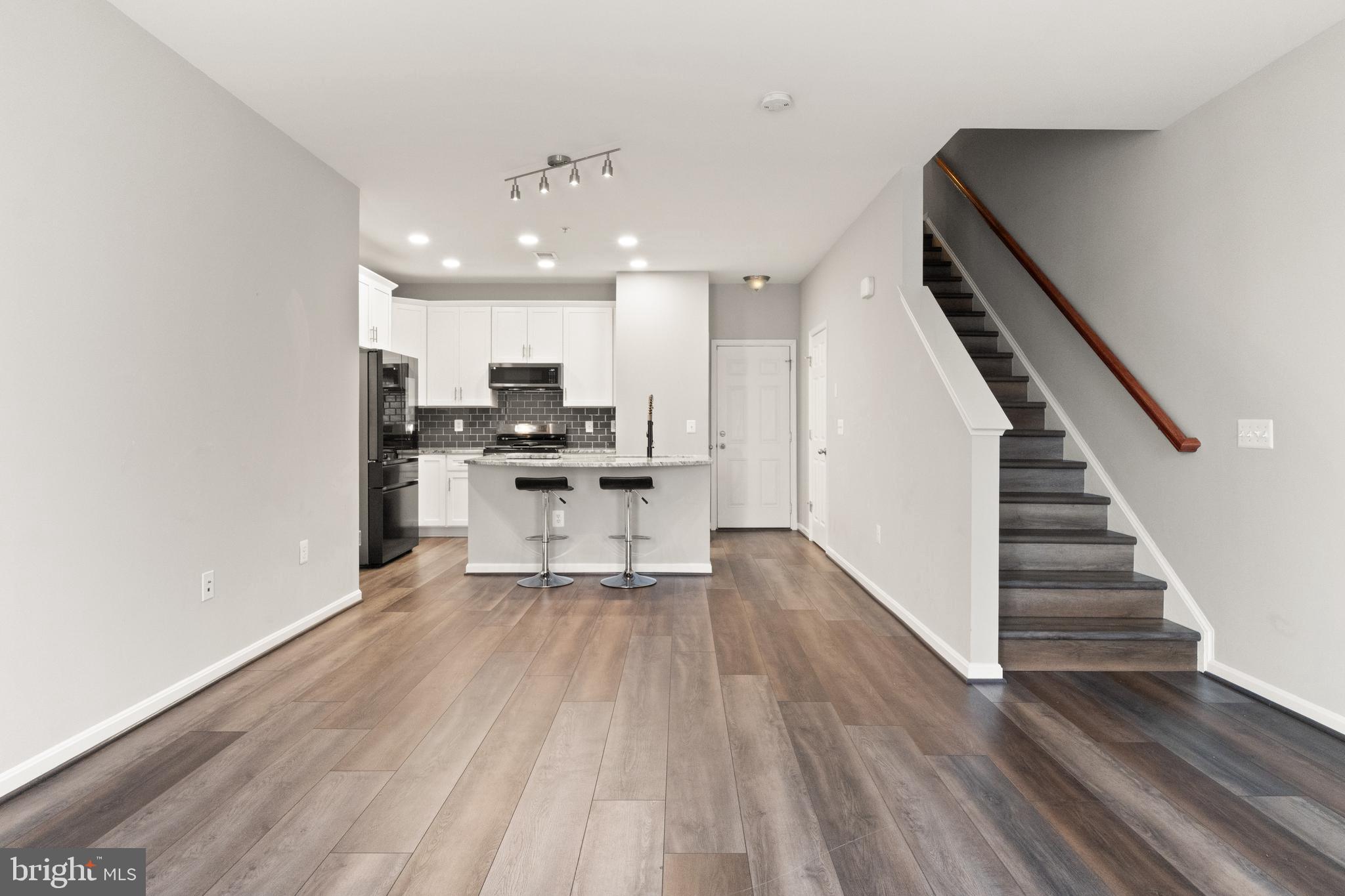 9541 Center Street Manassas, VA 20110 - Photo 6 of 41 a view of kitchen with wooden floor electronic appliances and stairs