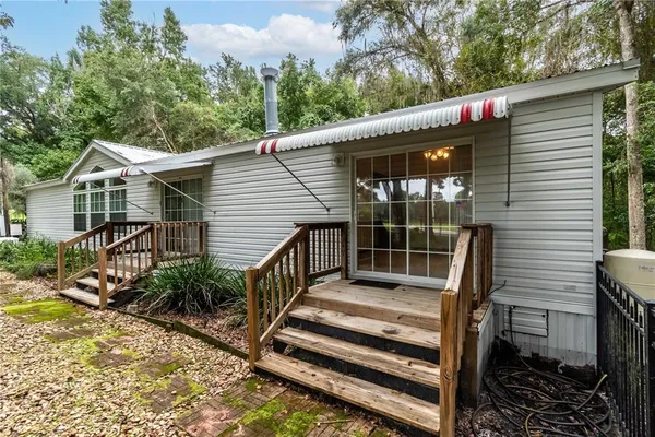 a view of a small house in the forest