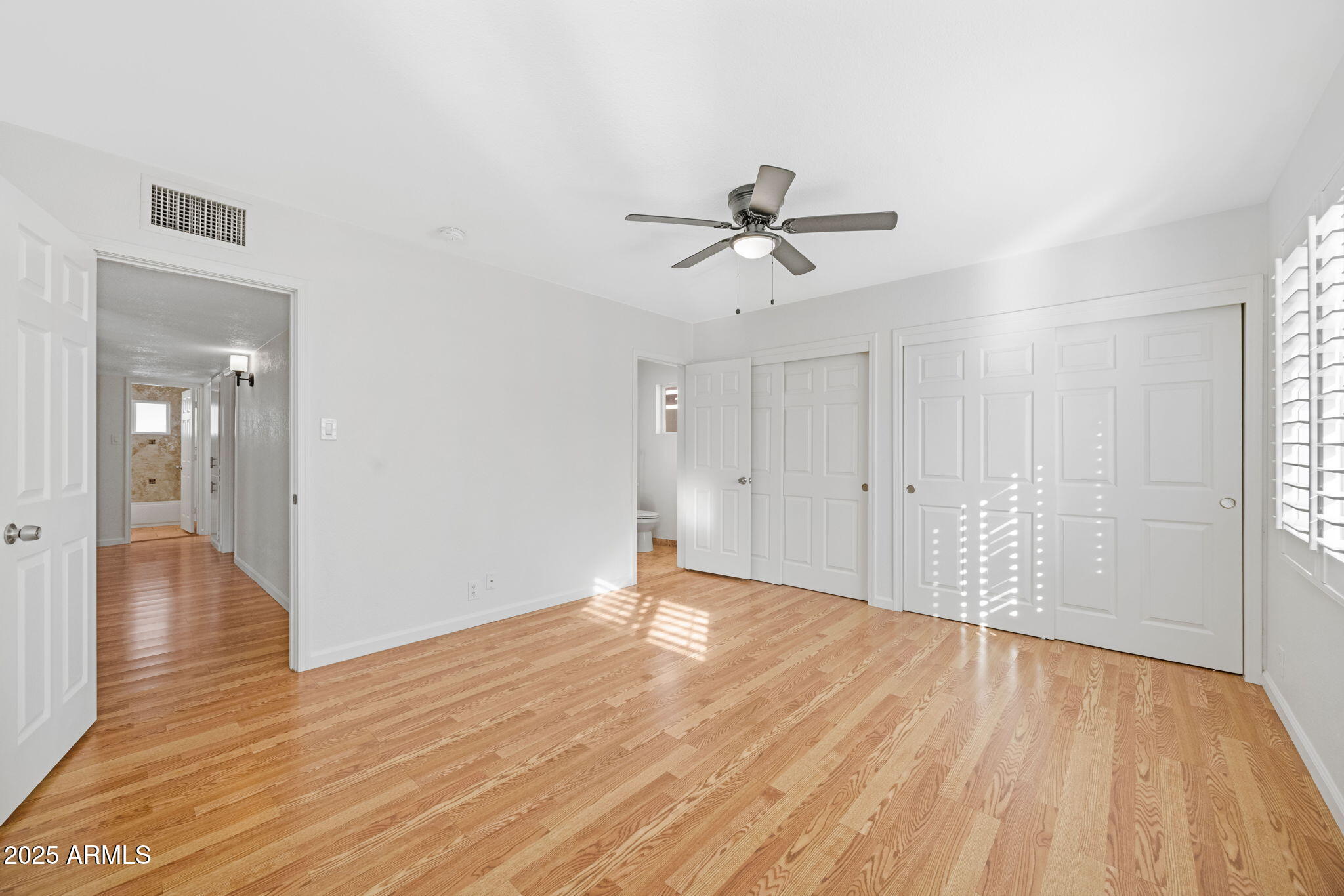 4020 North 44th Place Phoenix, AZ 85018 - Photo 11 of 17 a view of empty room with wooden floor and window