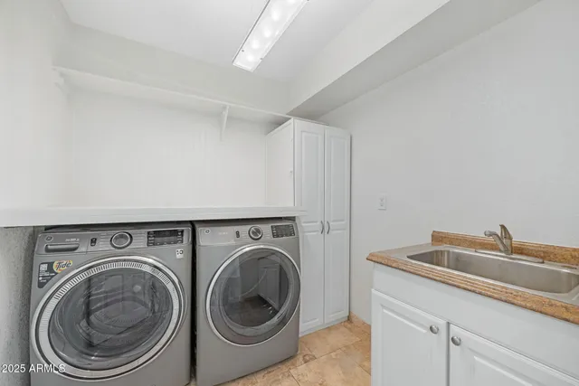 a utility room with sink dryer and washer