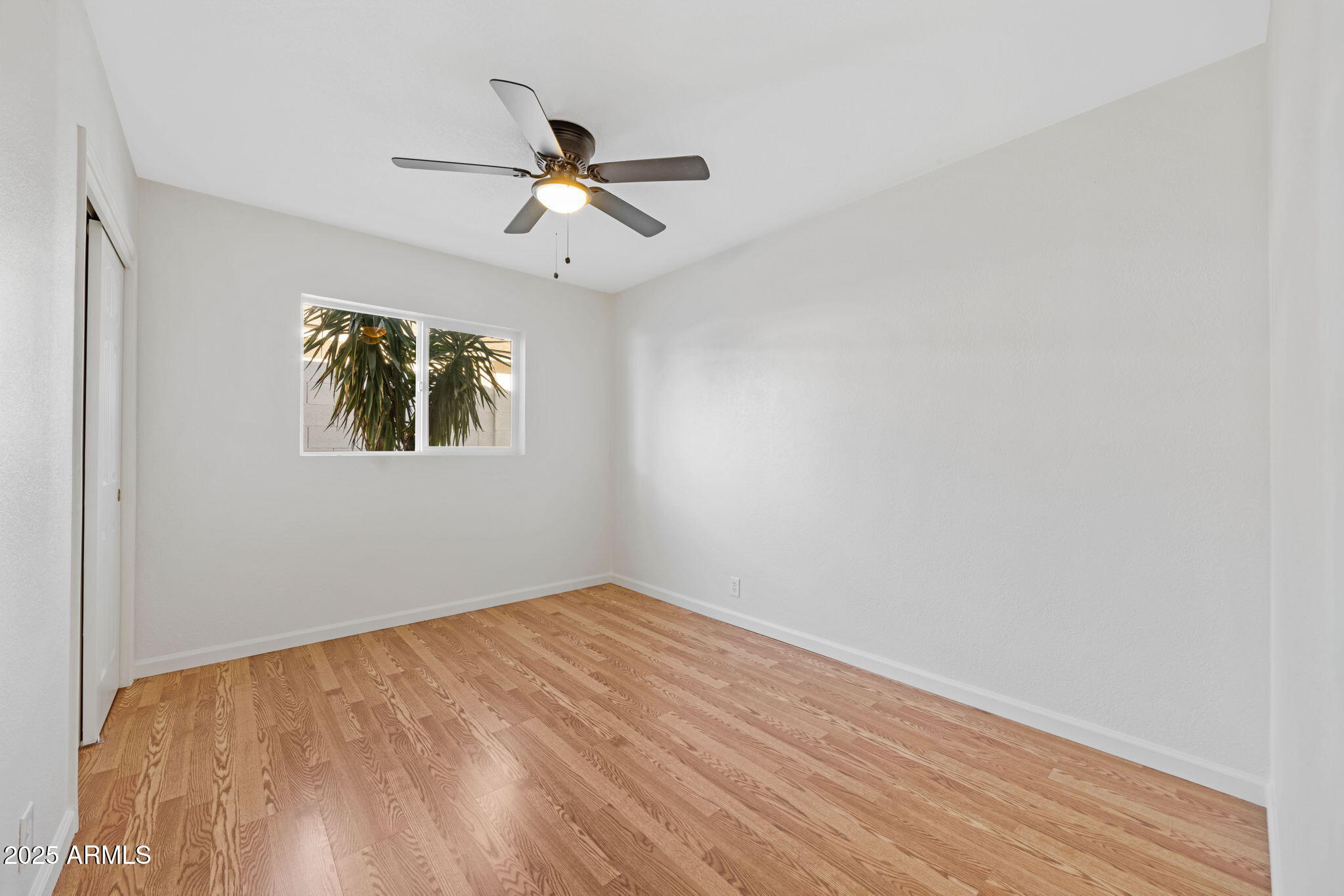 4020 North 44th Place Phoenix, AZ 85018 - Photo 14 of 17 a view of empty room with wooden floor and fan