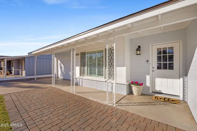 a front view of a house with a basket ball court and chair