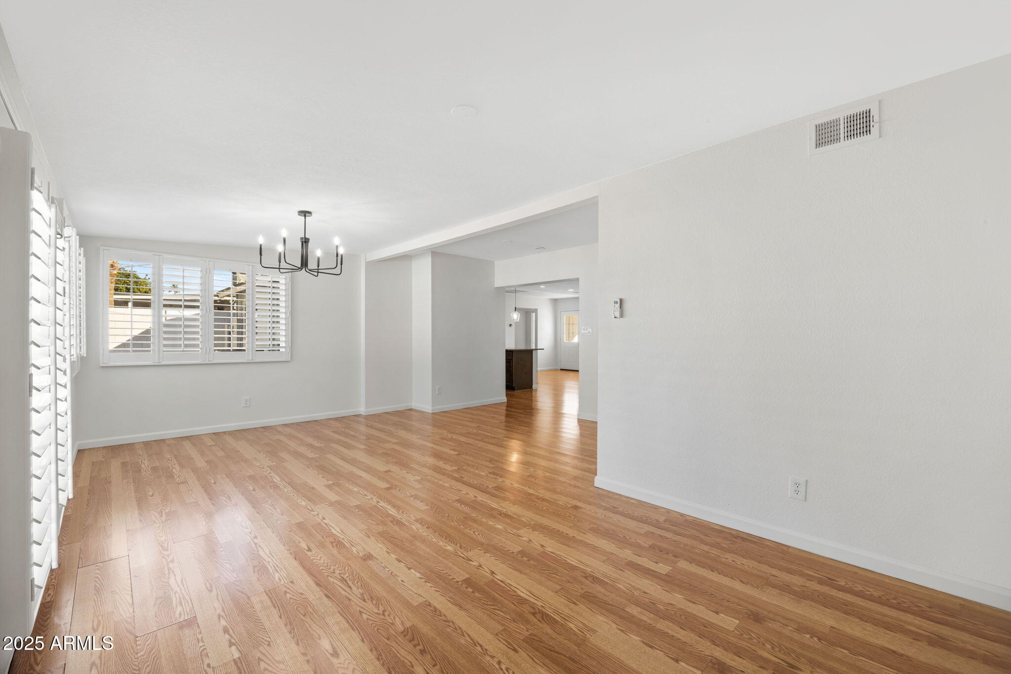 4020 North 44th Place Phoenix, AZ 85018 - Photo 9 of 17 a view of a big room with wooden floor and windows